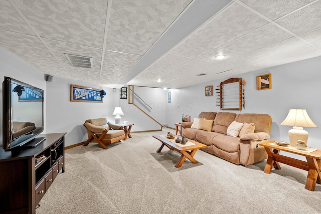 carpeted living room featuring visible vents and baseboards