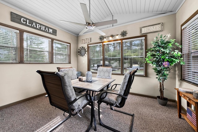 dining space featuring carpet floors, a wealth of natural light, vaulted ceiling, and baseboards