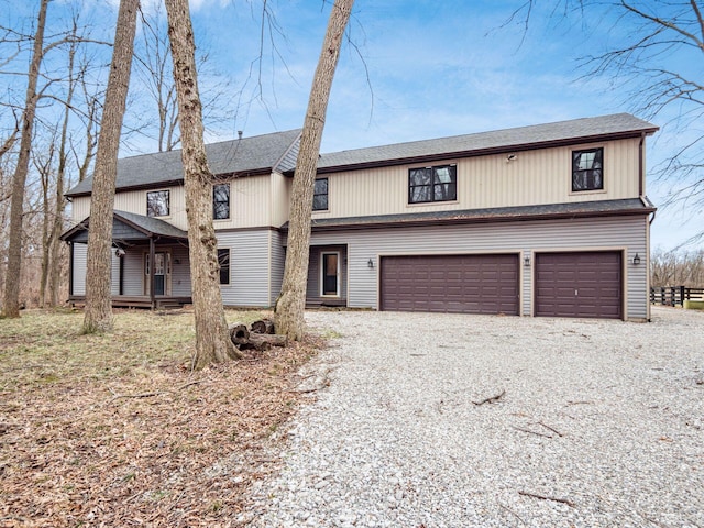 767 London Groveport Rd, Lockbourne, OH 43137 - view of front of home featuring a garage, a shingled roof, and gravel driveway