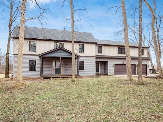 view of front of house featuring an attached garage, a front lawn, and roof with shingles