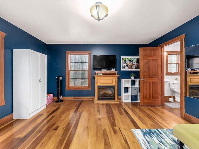 767 London Groveport Rd, Lockbourne, OH 43137 - unfurnished living room with a fireplace, baseboards, and wood finished floors