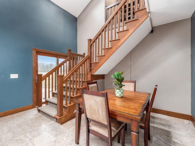 767 London Groveport Rd, Lockbourne, OH 43137 - dining area with a high ceiling, stairway, and baseboards