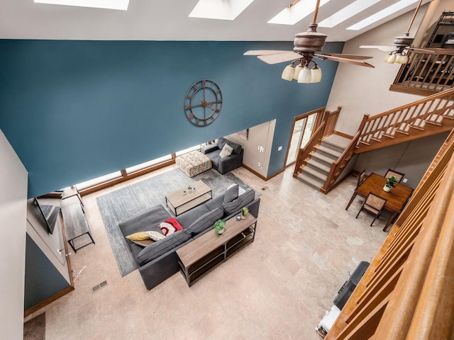767 London Groveport Rd, Lockbourne, OH 43137 - living area with ceiling fan, high vaulted ceiling, a skylight, baseboards, and stairs