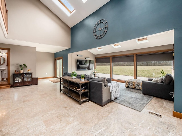 767 London Groveport Rd, Lockbourne, OH 43137 - living room featuring high vaulted ceiling, a skylight, visible vents, and baseboards