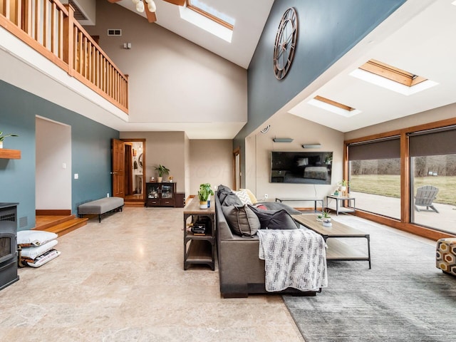 767 London Groveport Rd, Lockbourne, OH 43137 - living room featuring a wood stove, a skylight, high vaulted ceiling, and visible vents