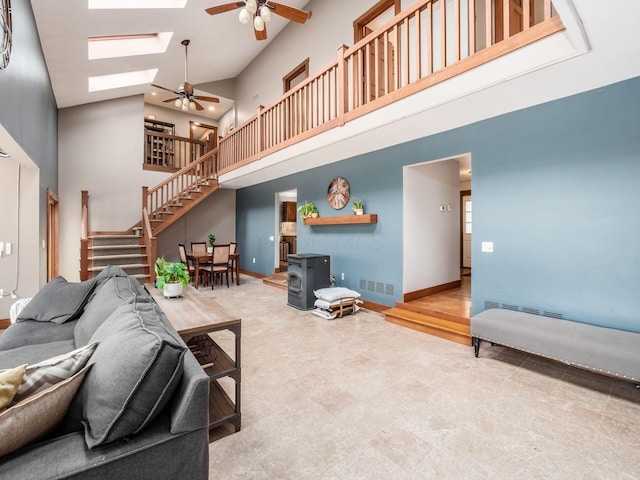 767 London Groveport Rd, Lockbourne, OH 43137 - living area with a skylight, visible vents, a towering ceiling, stairway, and a wood stove