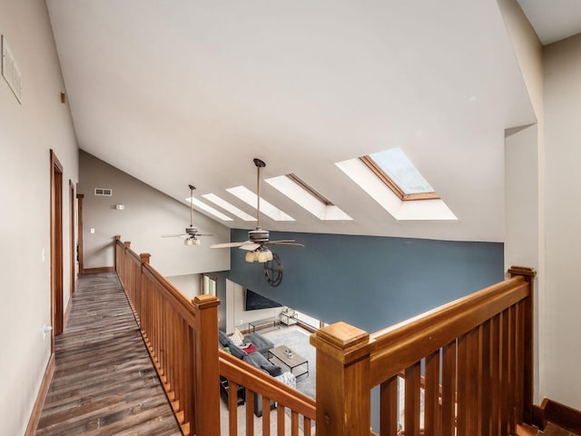 767 London Groveport Rd, Lockbourne, OH 43137 - hallway with baseboards, visible vents, lofted ceiling, wood finished floors, and an upstairs landing