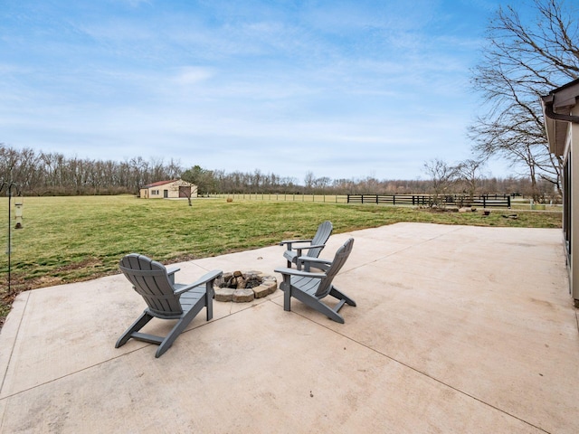 767 London Groveport Rd, Lockbourne, OH 43137 - view of patio featuring an outdoor fire pit, a rural view, an outdoor structure, and fence