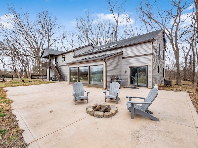 767 London Groveport Rd, Lockbourne, OH 43137 - rear view of property with an outdoor fire pit, driveway, stairway, a wooden deck, and a patio area