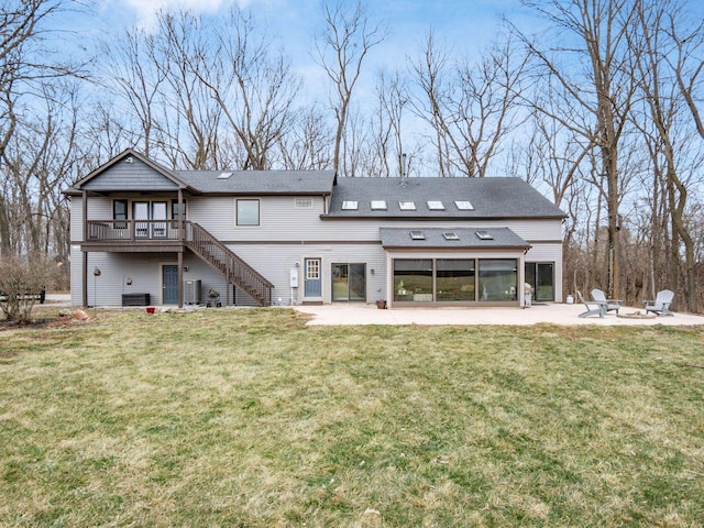 767 London Groveport Rd, Lockbourne, OH 43137 - back of property with a sunroom, stairway, a deck, a yard, and a patio area
