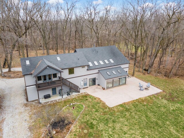 767 London Groveport Rd, Lockbourne, OH 43137 - rear view of property featuring a yard, roof with shingles, concrete driveway, and a patio