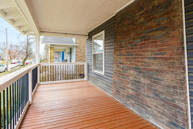 wooden terrace with a porch and a residential view