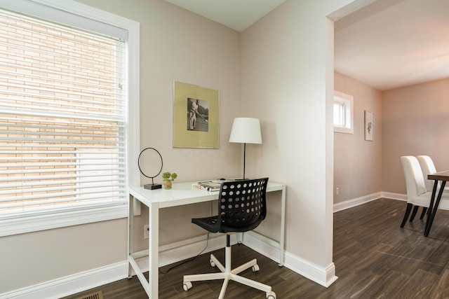 office space with dark wood finished floors and baseboards