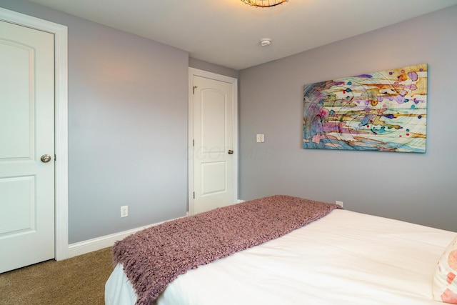 carpeted bedroom featuring baseboards