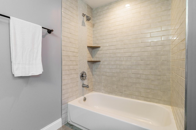 bathroom featuring baseboards and shower / bathing tub combination