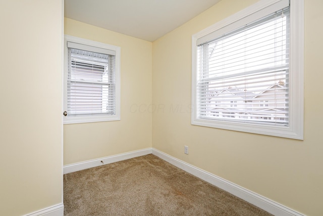 empty room with carpet flooring and baseboards