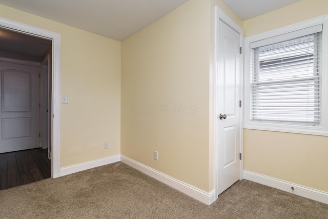 interior space with carpet floors and baseboards