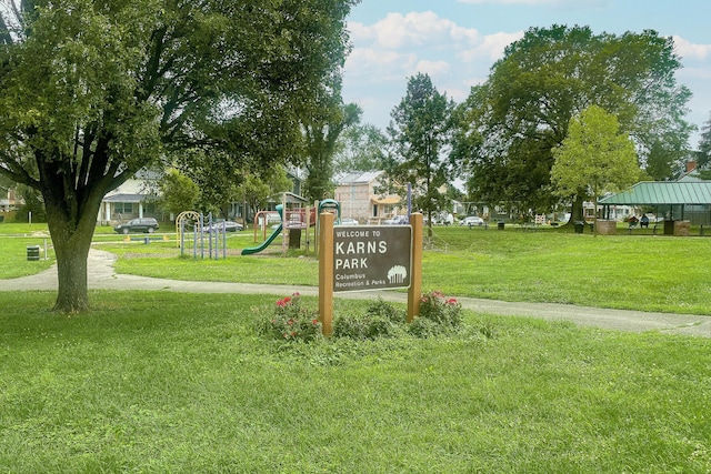 surrounding community with playground community and a yard