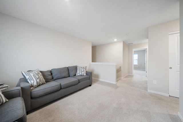 living area with light carpet, recessed lighting, and baseboards