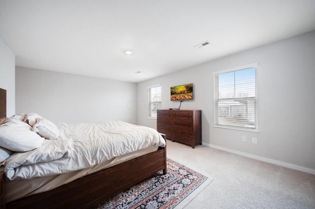 bedroom featuring light colored carpet, visible vents, and baseboards