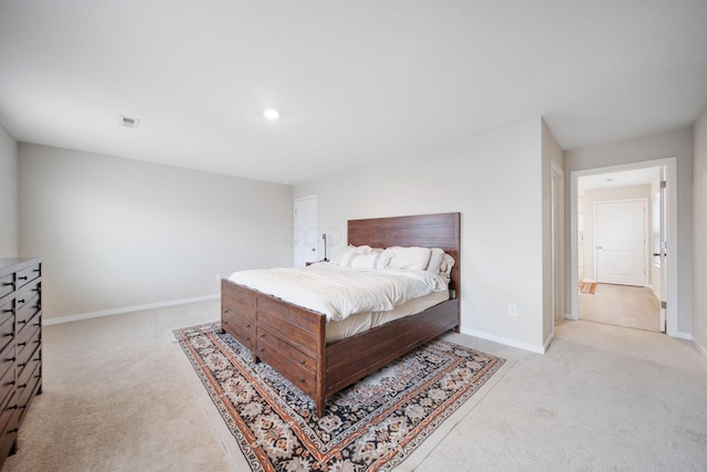 bedroom featuring light carpet, visible vents, and baseboards