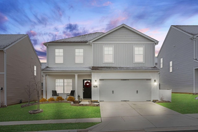 214 Sandburg Dr, Lithopolis, OH 43136 - traditional home featuring a garage, concrete driveway, covered porch, a yard, and board and batten siding