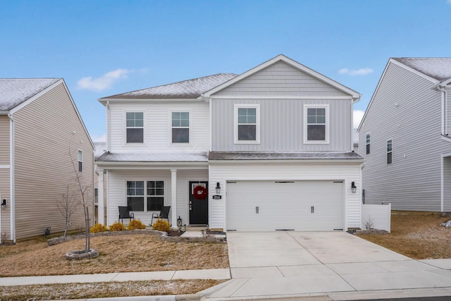 traditional-style home with covered porch, driveway, board and batten siding, and an attached garage