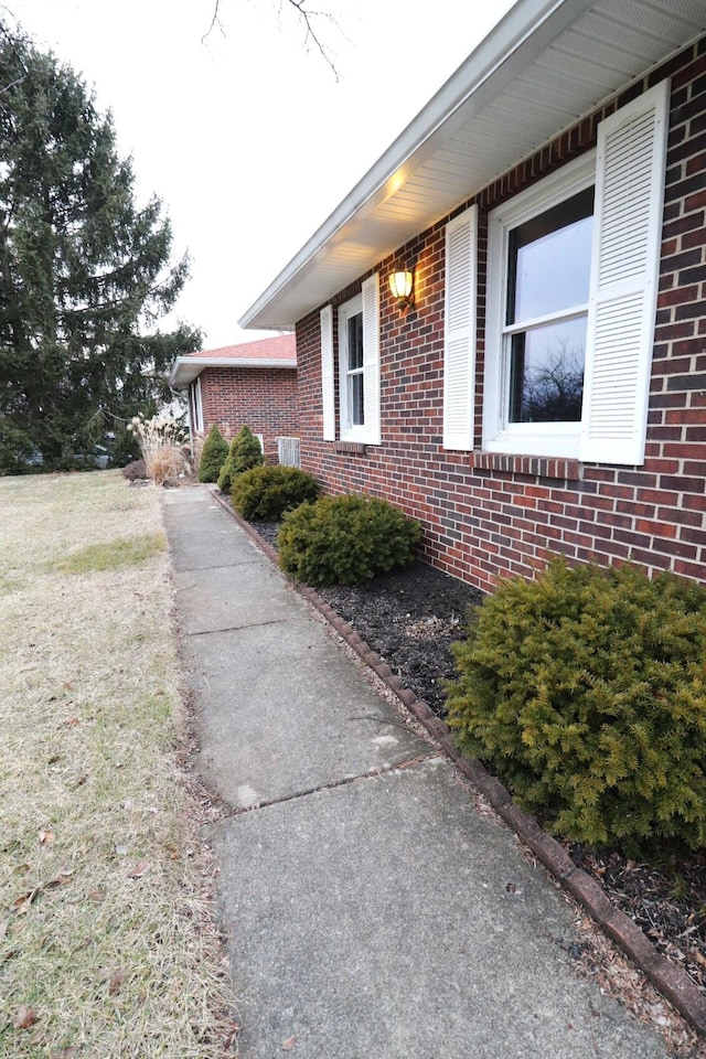 view of side of property with brick siding