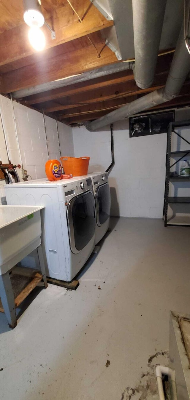 clothes washing area featuring washer and dryer and laundry area