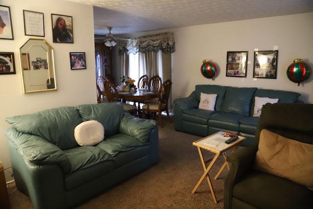 living room featuring a textured ceiling, a ceiling fan, and carpet floors