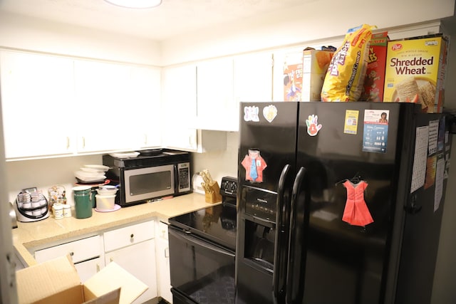 kitchen featuring white cabinetry, black appliances, and light countertops