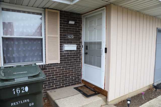 view of exterior entry with brick siding