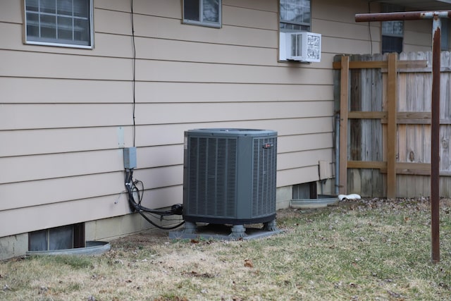 exterior details featuring cooling unit and fence