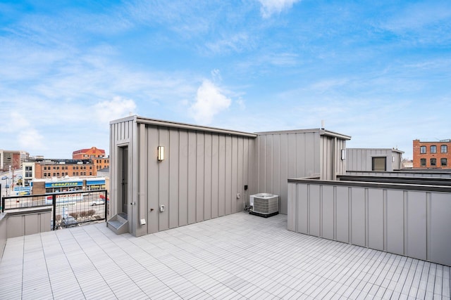 view of patio with a balcony and cooling unit