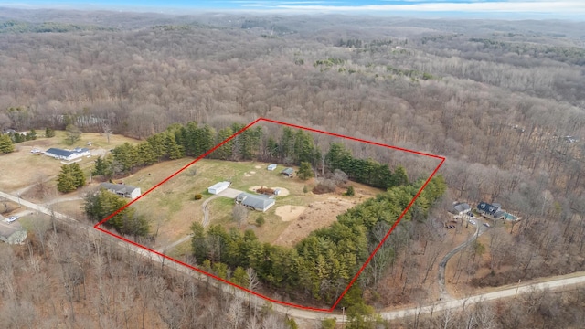 bird's eye view featuring a wooded view and a rural view