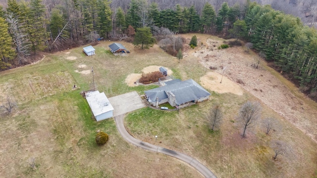 birds eye view of property with a view of trees