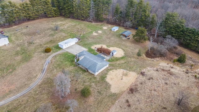 drone / aerial view featuring a forest view