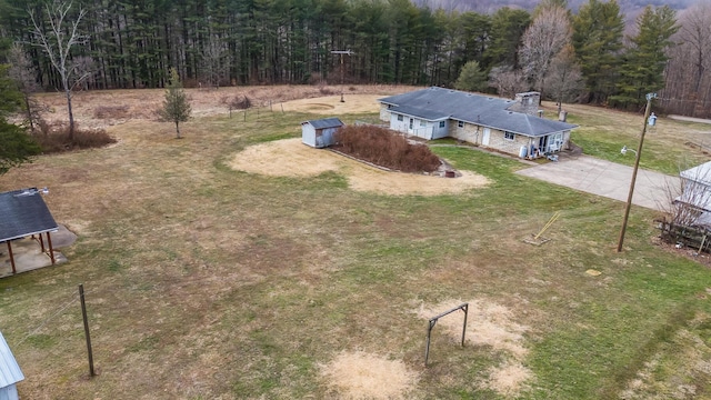 drone / aerial view featuring a forest view