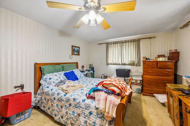 carpeted bedroom featuring wallpapered walls and ceiling fan