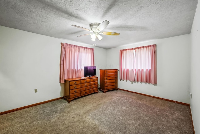 carpeted bedroom featuring ceiling fan, baseboards, and a textured ceiling