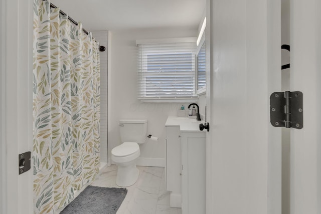 full bathroom with baseboards, toilet, a shower with curtain, marble finish floor, and vanity