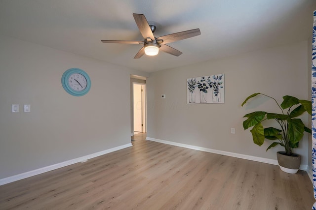 spare room with light wood-style floors, ceiling fan, and baseboards