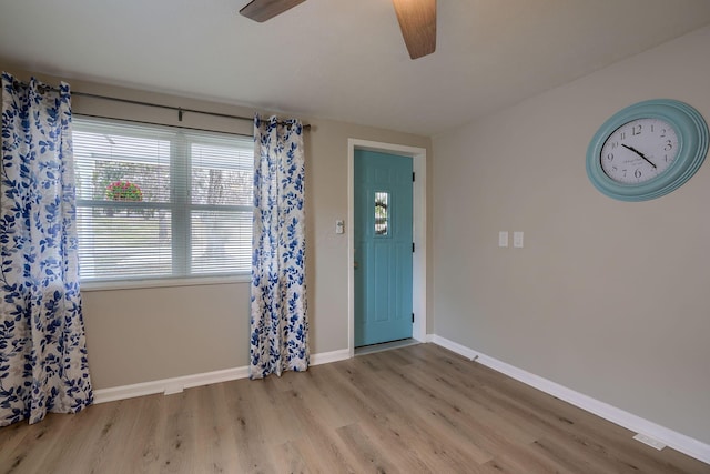 entrance foyer with ceiling fan, baseboards, and wood finished floors