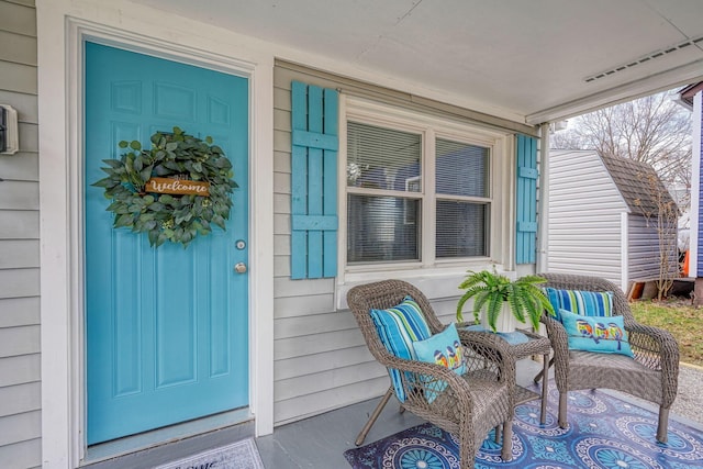 entrance to property with a porch and visible vents