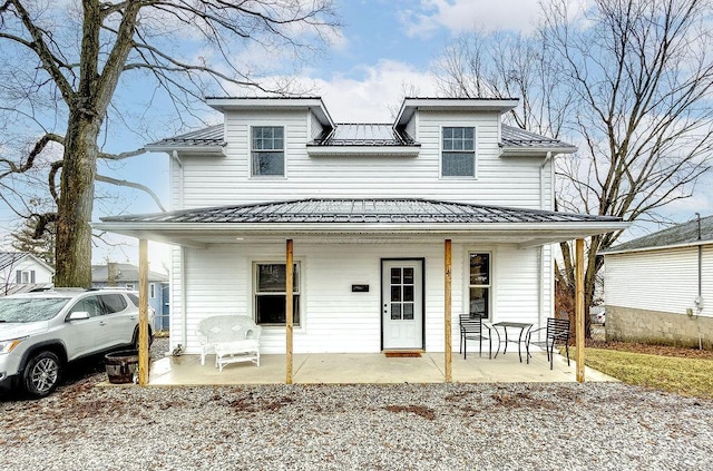 view of front of property featuring covered porch and metal roof