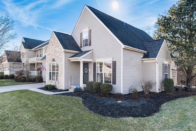 view of property exterior featuring a shingled roof and a yard