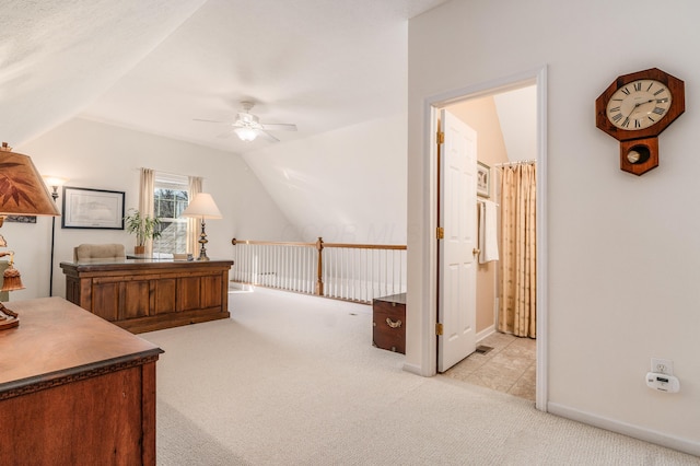 interior space featuring ceiling fan, baseboards, and vaulted ceiling