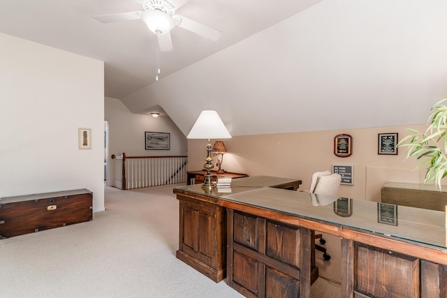 office featuring light carpet, ceiling fan, and lofted ceiling