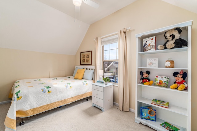 bedroom featuring light carpet, vaulted ceiling, baseboards, and ceiling fan