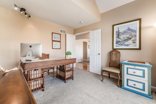 office featuring carpet, track lighting, visible vents, and baseboards